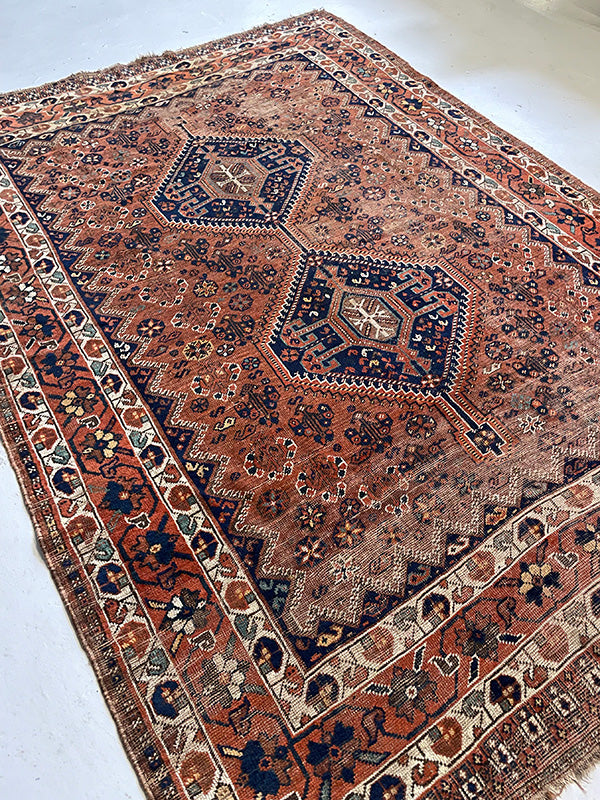 Decorative rug with intricate patterns on a white background