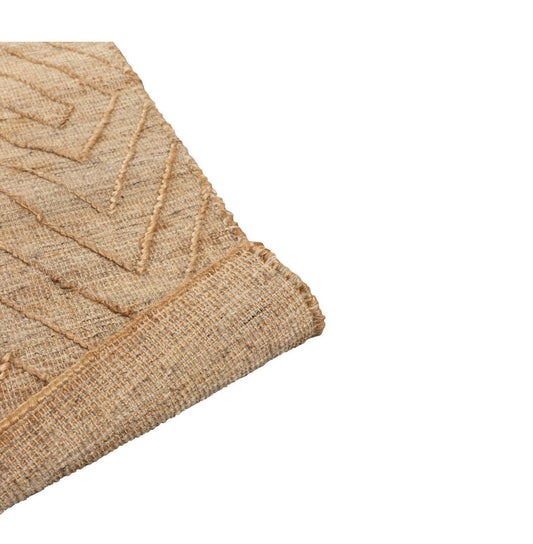 Close-up of a textured beige rug corner on a white background