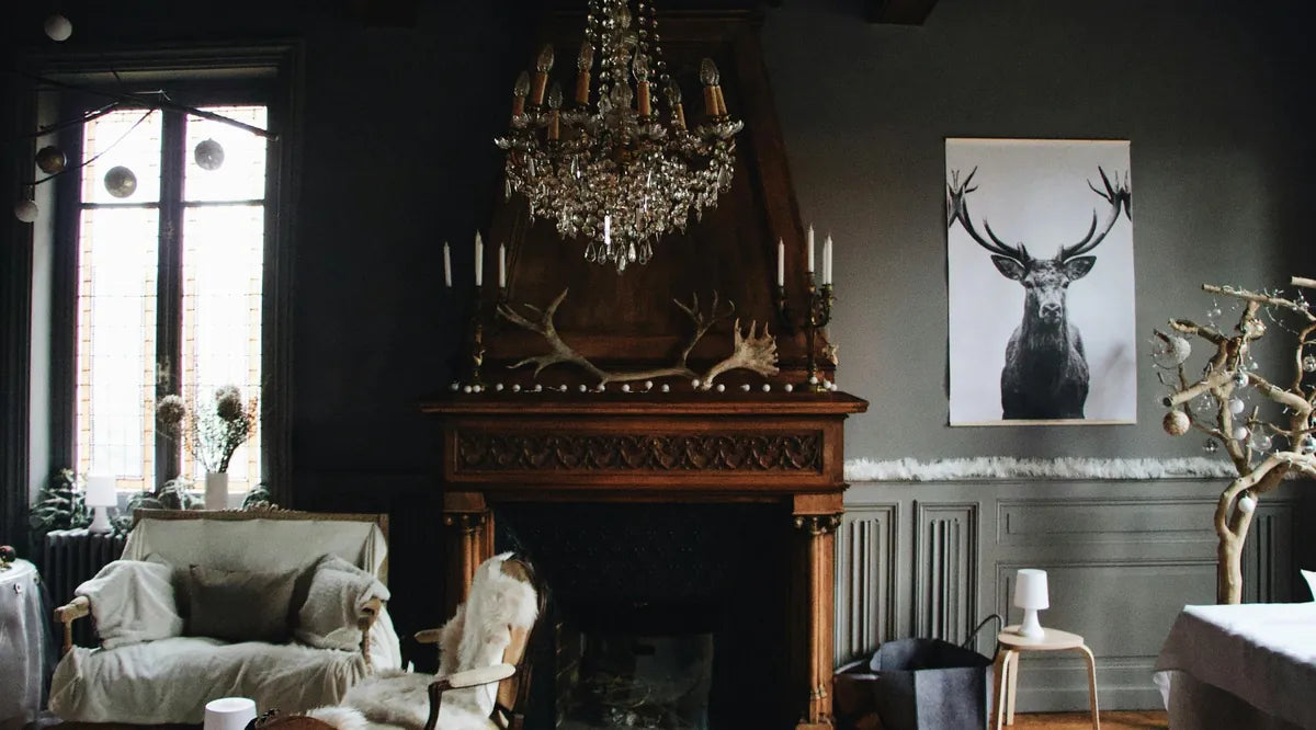 Living room with dark walls, a chandelier, and a deer head mounted on the wall.