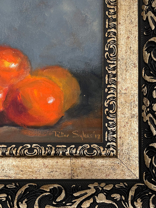 Framed still life painting of oranges with decorative frame