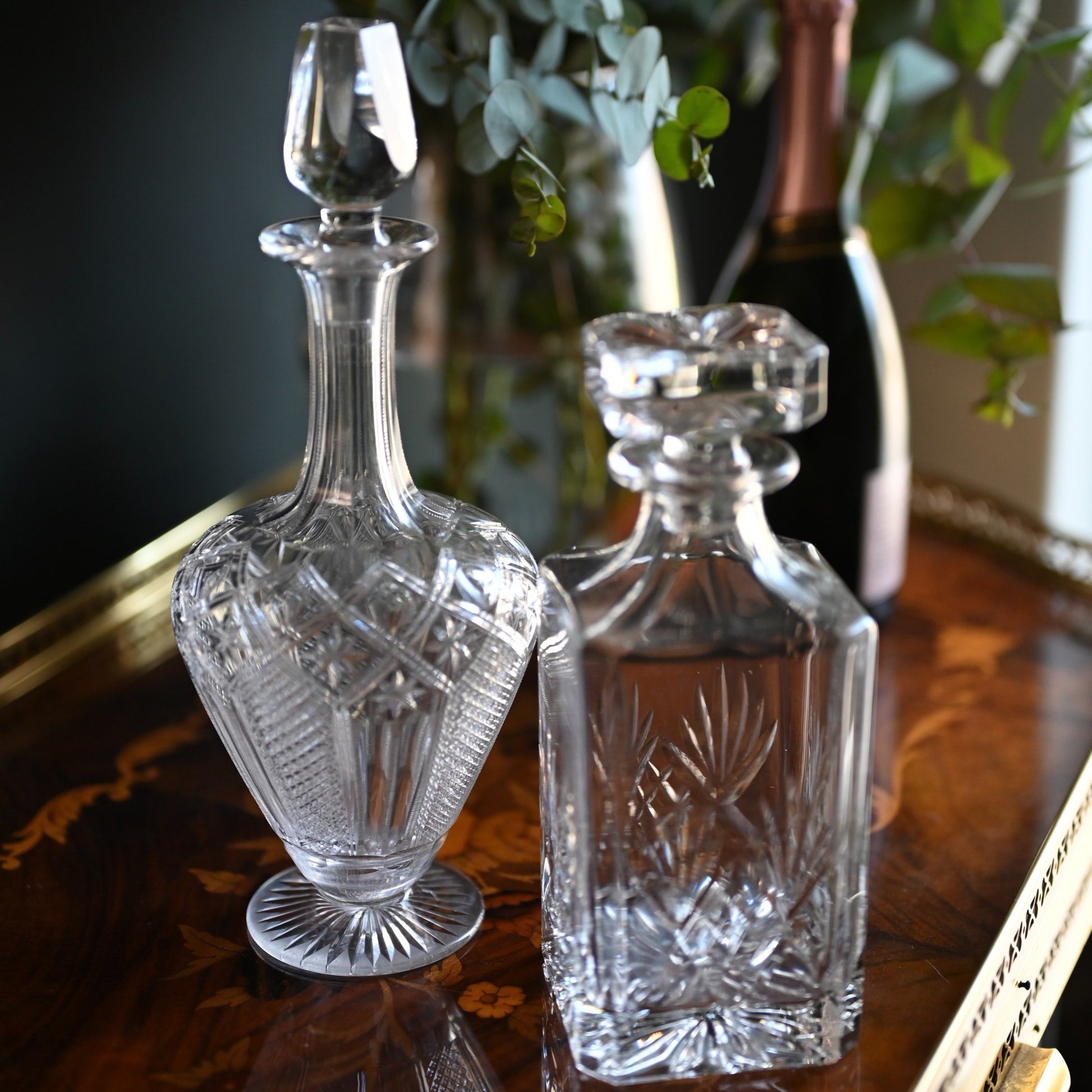 A timeless pairing of cut crystal decanters, each offering its own distinct silhouette and elegance.