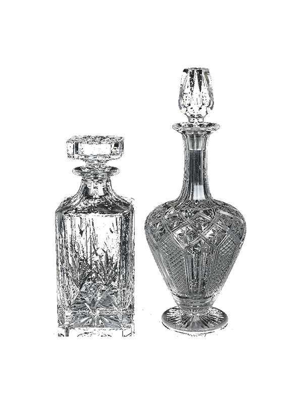 Two vintage crystal decanters on a white background