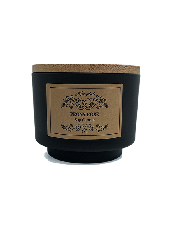 Black candle with a brown label on a white background