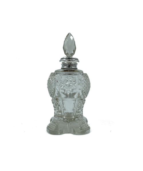 Decorative perfume bottle with intricate design on a white background