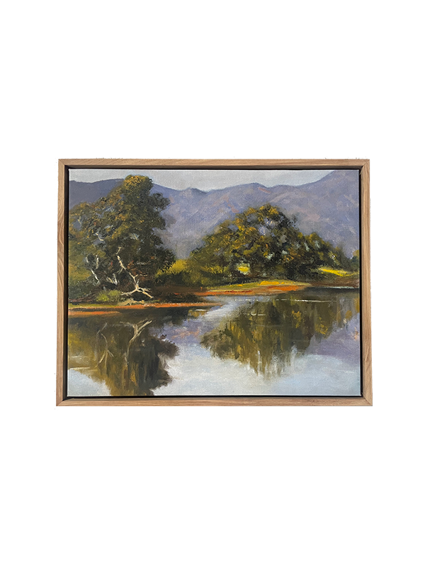 Framed original oil painting of a landscape with trees and mountains reflected in water.