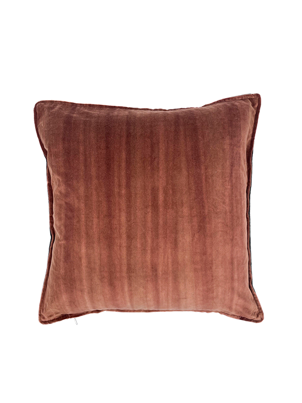 Rust colour velvet pillow on a white background