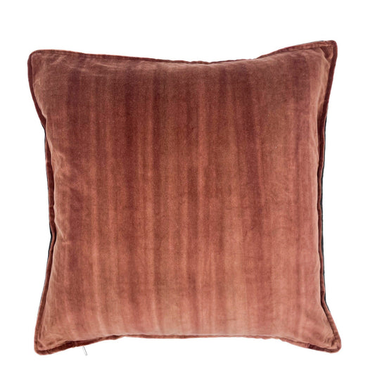 Rust colour velvet pillow on a white background