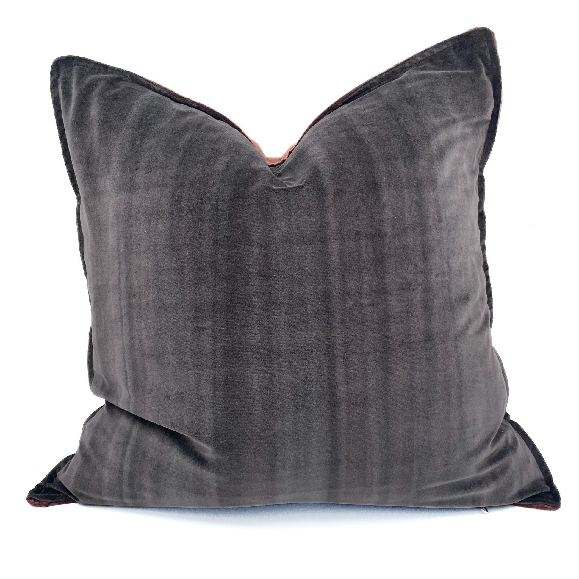 Gray velvet pillow on a white background