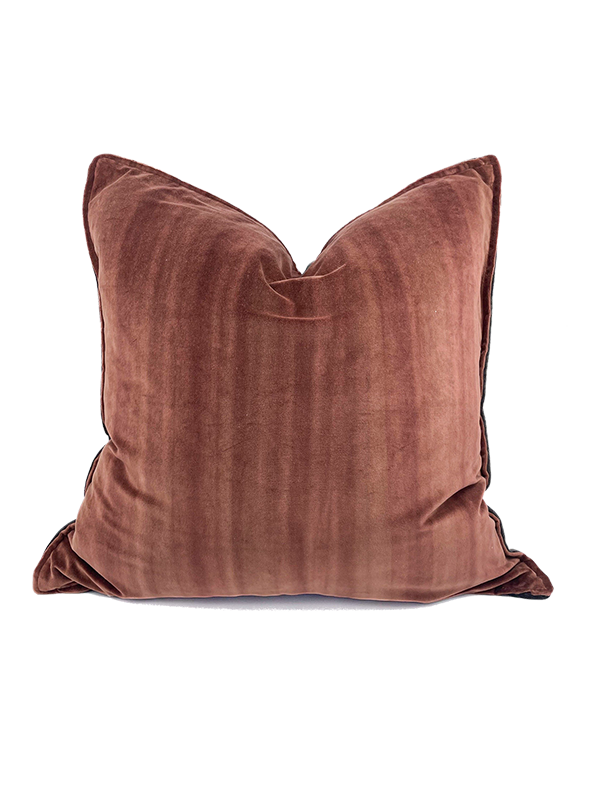 Rust colour velvet pillow on a white background