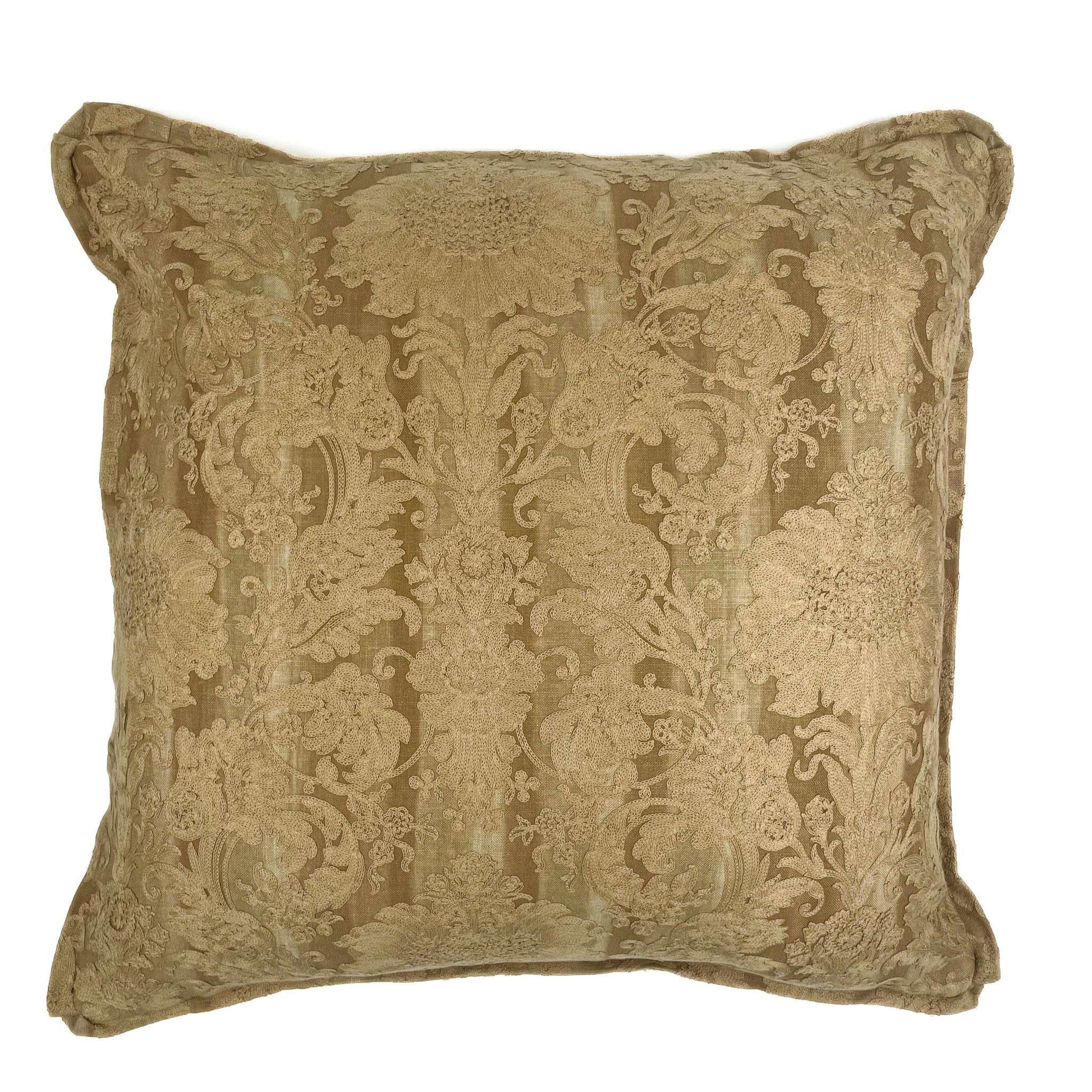Decorative pillow with intricate gold pattern on a white background