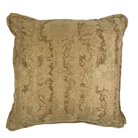 Decorative pillow with intricate gold pattern on a white background
