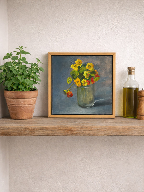 Framed still life painting of flowers on a wooden shelf with plants and bottles.