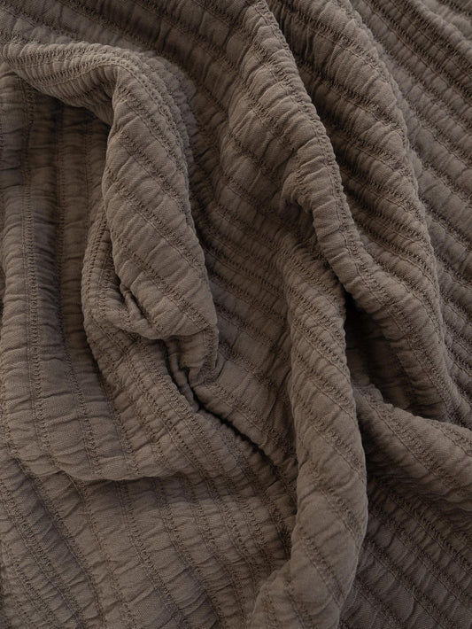 Close-up of textured mocha colour throw