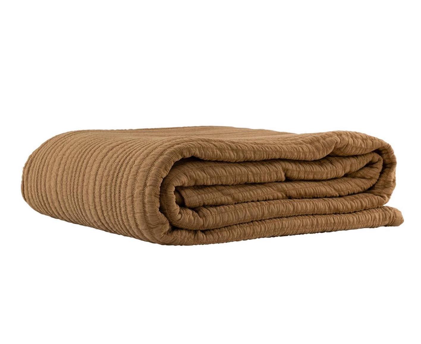 Folded nutmeg coloured blanket on a white background