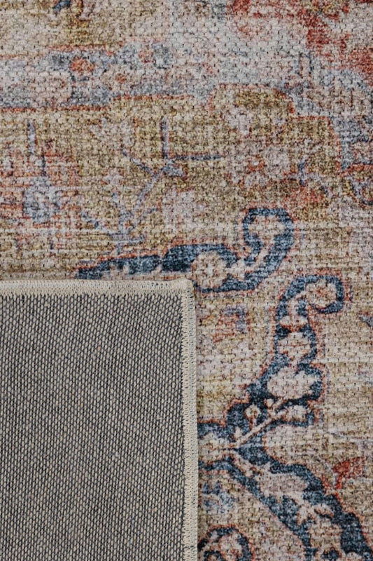 Unveil a sense of quiet grandeur with this rug—a faded tapestry of soft blush, antique gold, and indigo scrollwork.