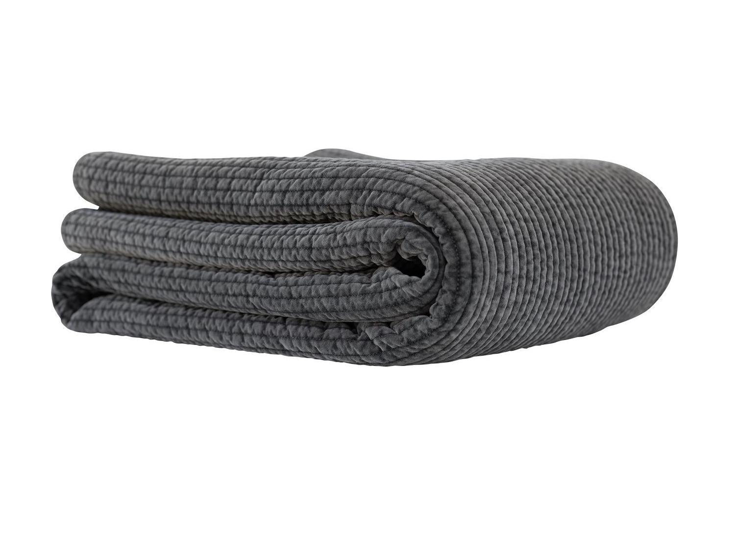 Textured grey quilt on a white background