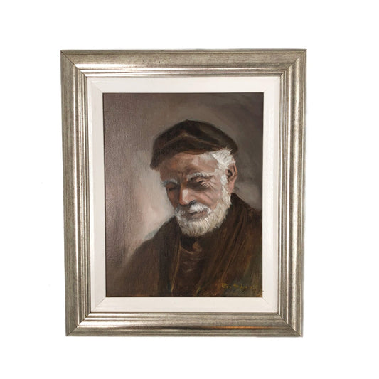 Framed painting of an elderly man with a white beard and cap on a white background