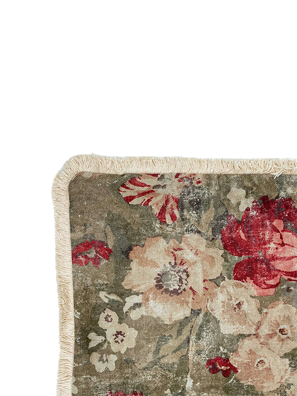 Floral patterned linen scatter cushion with red and pink flowers on a beige background