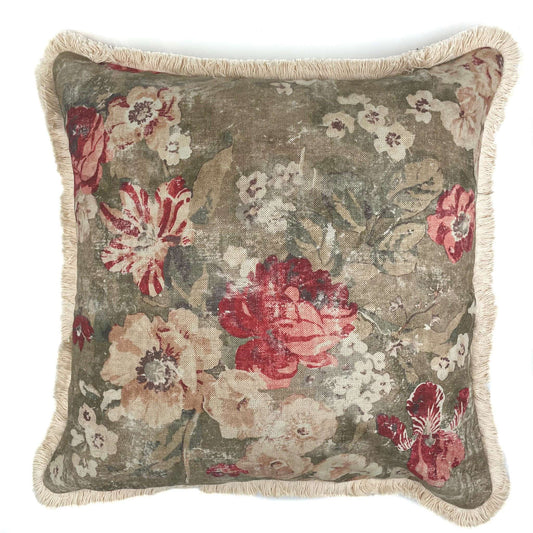 Floral patterned pillow with red and pink flowers on a beige background