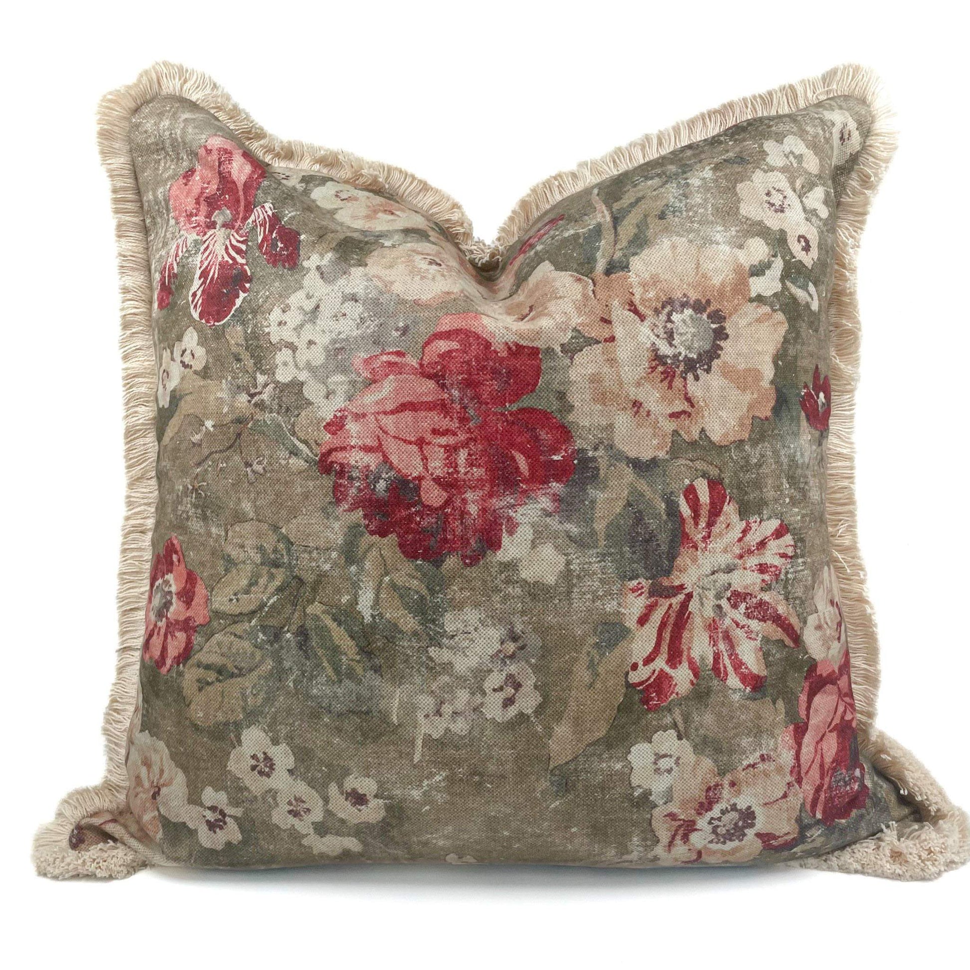 Floral patterned pillow with red and beige flowers on a white background