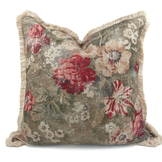 Floral patterned pillow with red and beige flowers on a white background