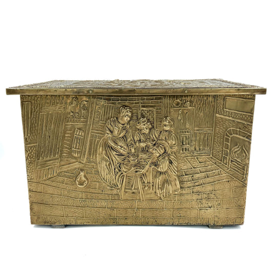 An embossed brass box from the late 19th century, crafted using repoussé techniques, depict a scenes of historical domestic life evoking a sense of nostalgia and tradition. 