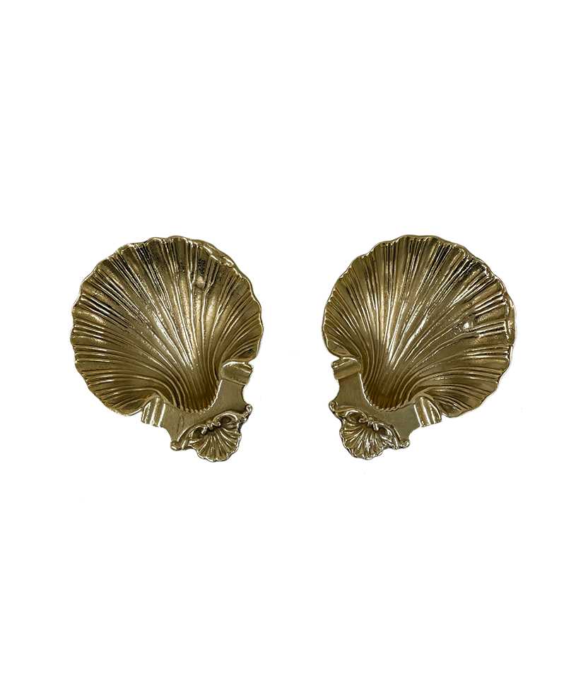 Two gold shell-shaped dishes on a white background