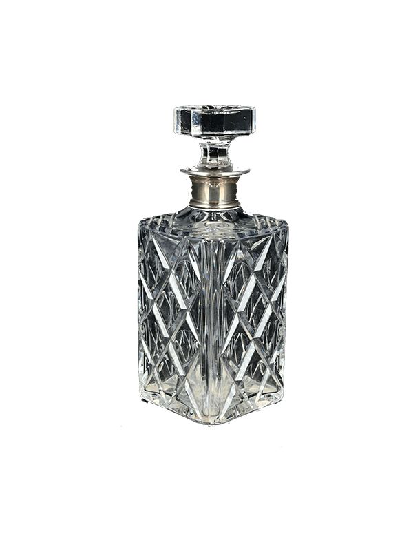 Crystal decanter with silver stopper on a white background