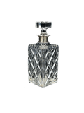 Crystal decanter with silver stopper on a white background