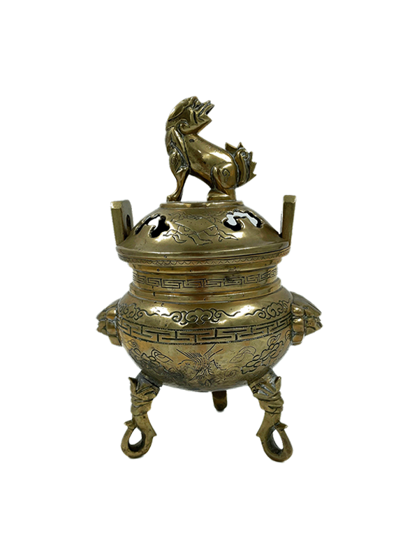 Vintage brass foo dog  incense burner against a white background