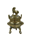 Vintage brass foo dog  incense burner against a white background