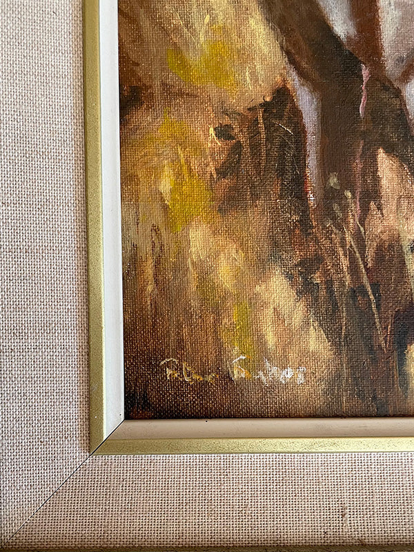 Close-up of a painting with a signature on a textured beige background
