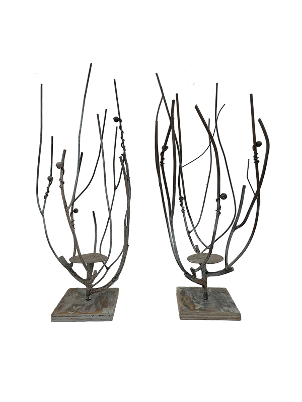 Two decorative candle holders with branch-like designs on a white background